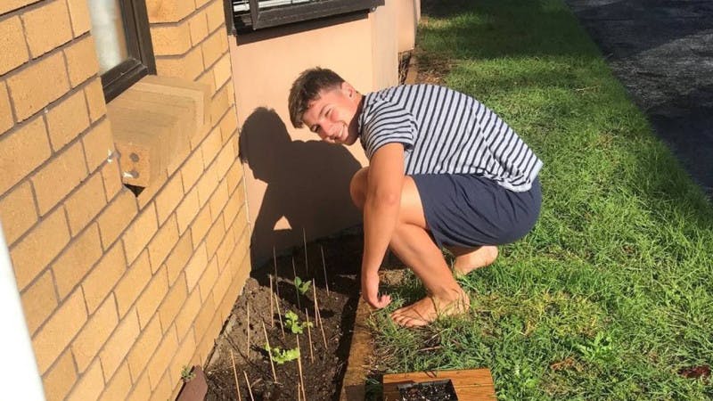 An international student gardening at his homestay in New Zealand.